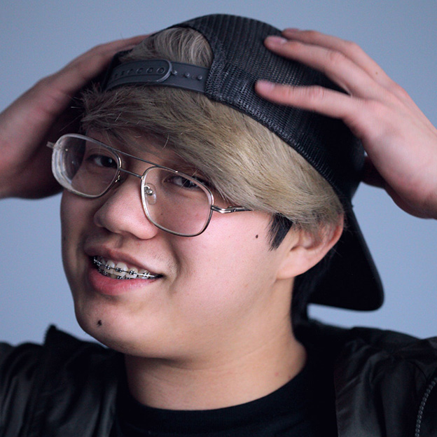 Teenage boy smiling while wearing braces.