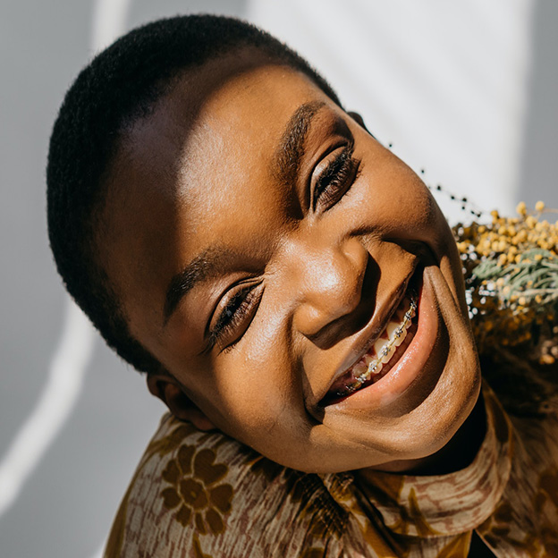 Girl smiling with metal braces.