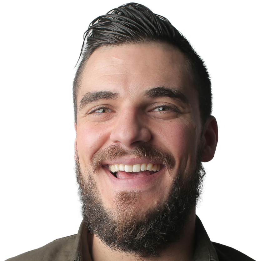 Adult patient smiling after completing orthodontic treatment