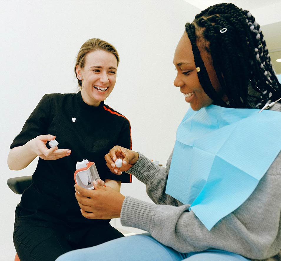 Clinician showing a patient a model of teeth